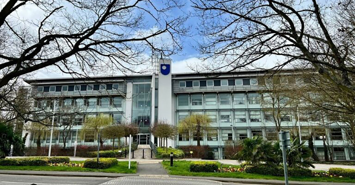 A modern building with multiple glass windows visible on the exterior.