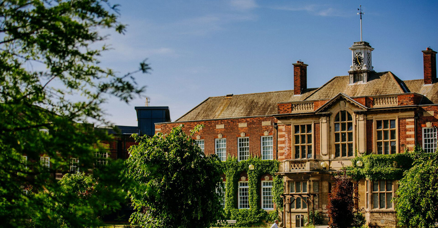 University of Hull building shown in close-up, with a green tree visible at the edge of the frame.